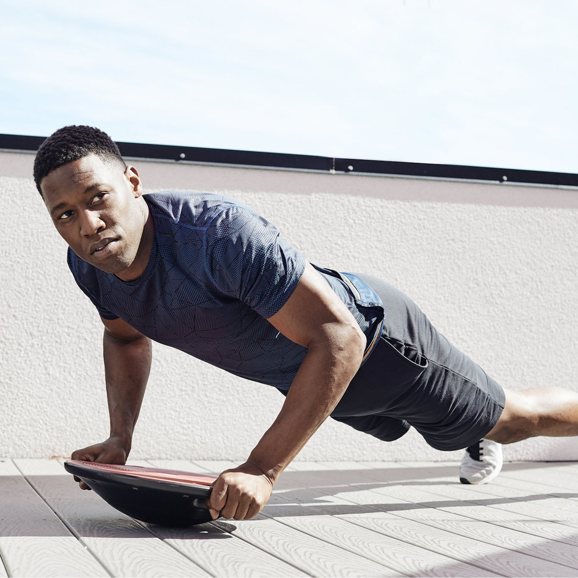 man doing pushup on core board