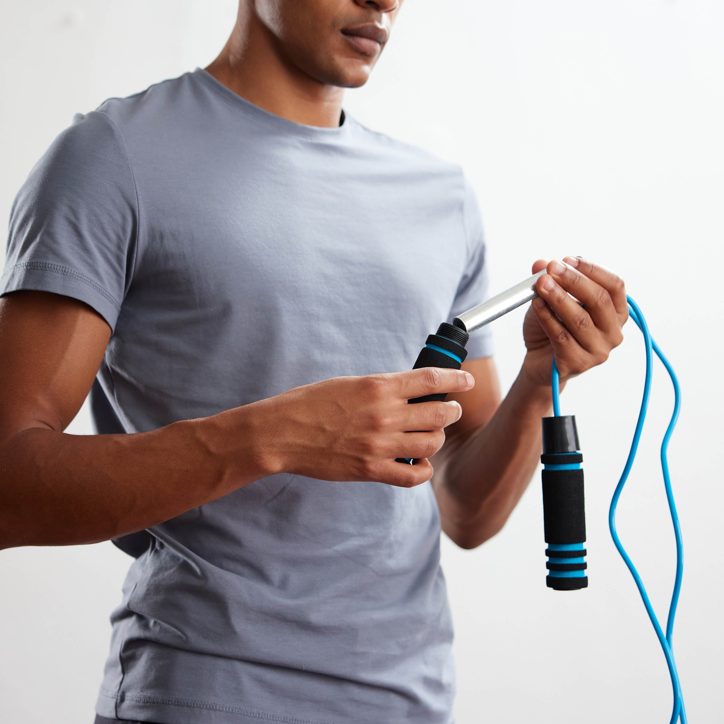 Person adjusting the weight in the handles of the Weighted Jump Rope