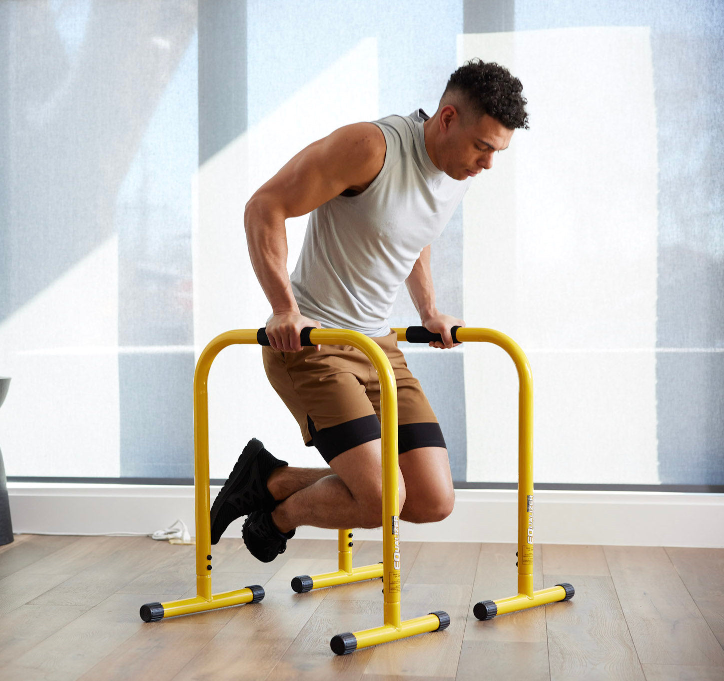 Man doing tricep dips on Lebert Equalizer Bars